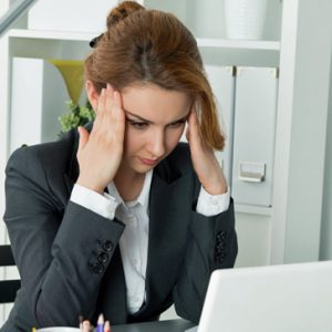Young beautiful business woman trying to concentrate